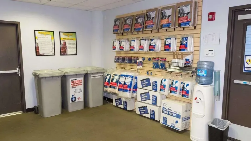 Moving and packing supplies on display along with secure document shredding trashcans, and a water station